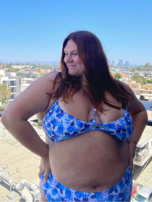 plus sized woman in blue floral underwire bikini top and matching high waisted bottoms