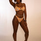 woman wearing a reversible orange / orange print high hip thong bikini bottoms with matching underwire top