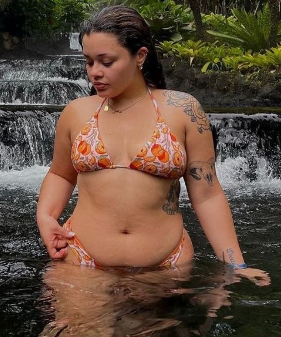 woman in orange print triangle bikini top