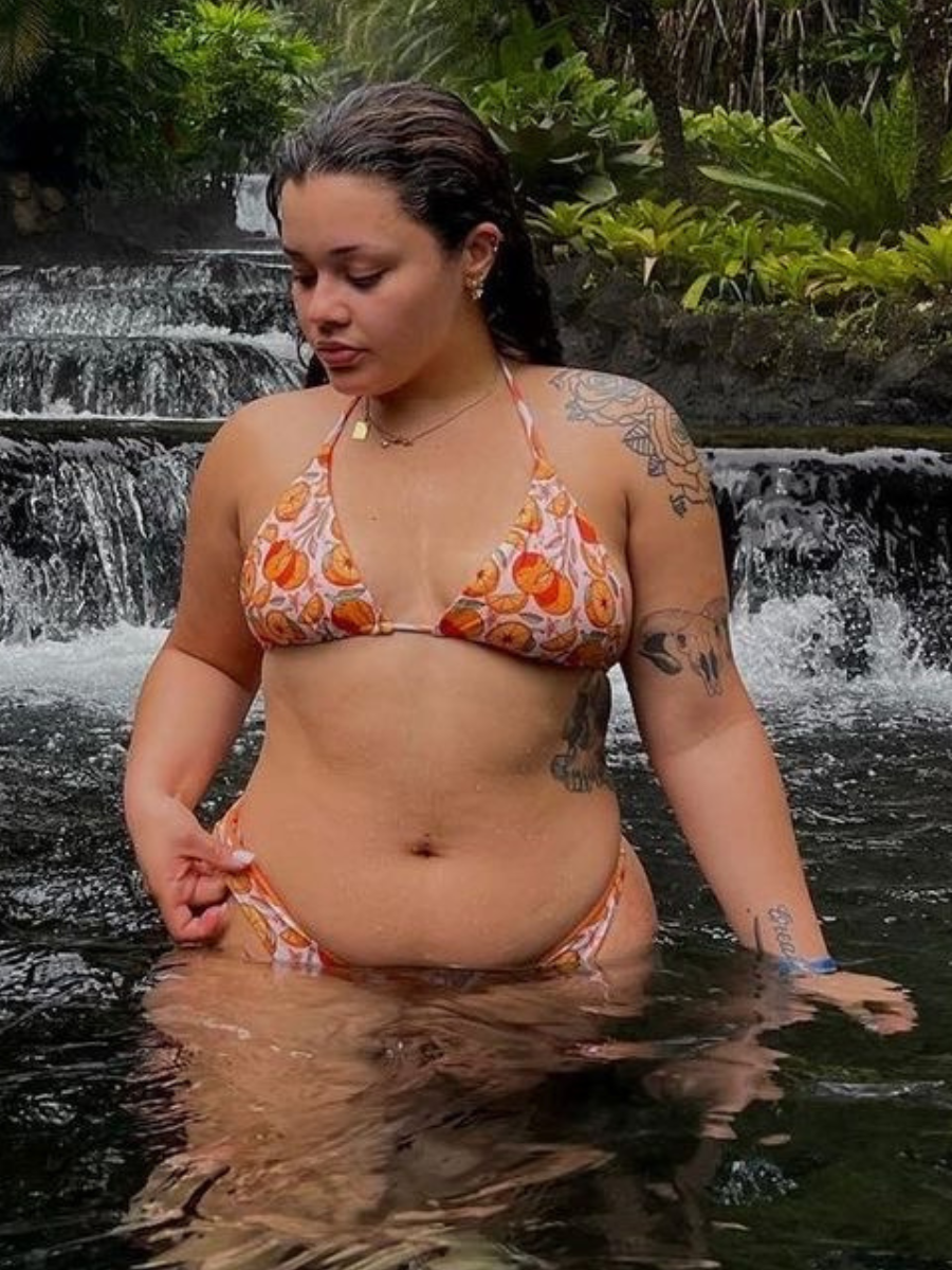 woman in orange print triangle bikini top