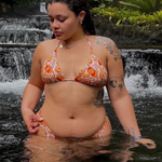woman in orange print triangle bikini top