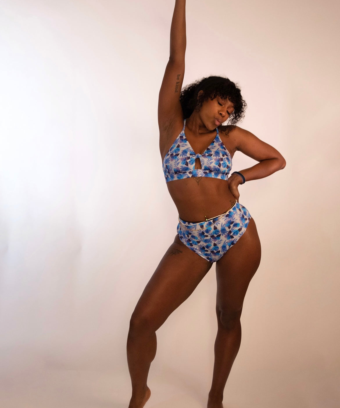woman in a supportive cross back blue floral bikini top and matching high waisted bottoms