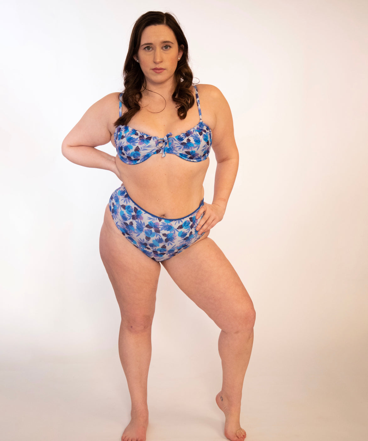 plus sized woman in blue floral underwire bikini top and matching high waisted bottoms