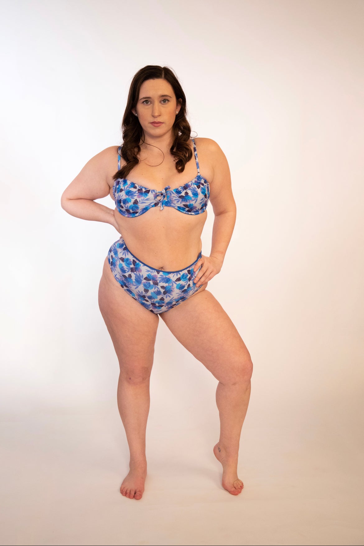 plus sized woman in blue floral underwire bikini top and matching high waisted bottoms