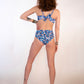 woman in blue floral underwire bikini top and matching high hip thong bottoms from behind 