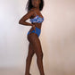 woman in blue floral underwire bikini top and solid blue reversible bikini bottoms