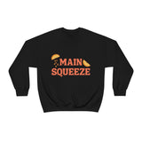black crewneck sweatshirt with a graphic that says "main squeeze" in orang font with graphics of orange slices