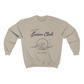 long sleeve, sand colored crewneck with a graphic of a wave in front of a circle with the words "Portside swim club" above it
