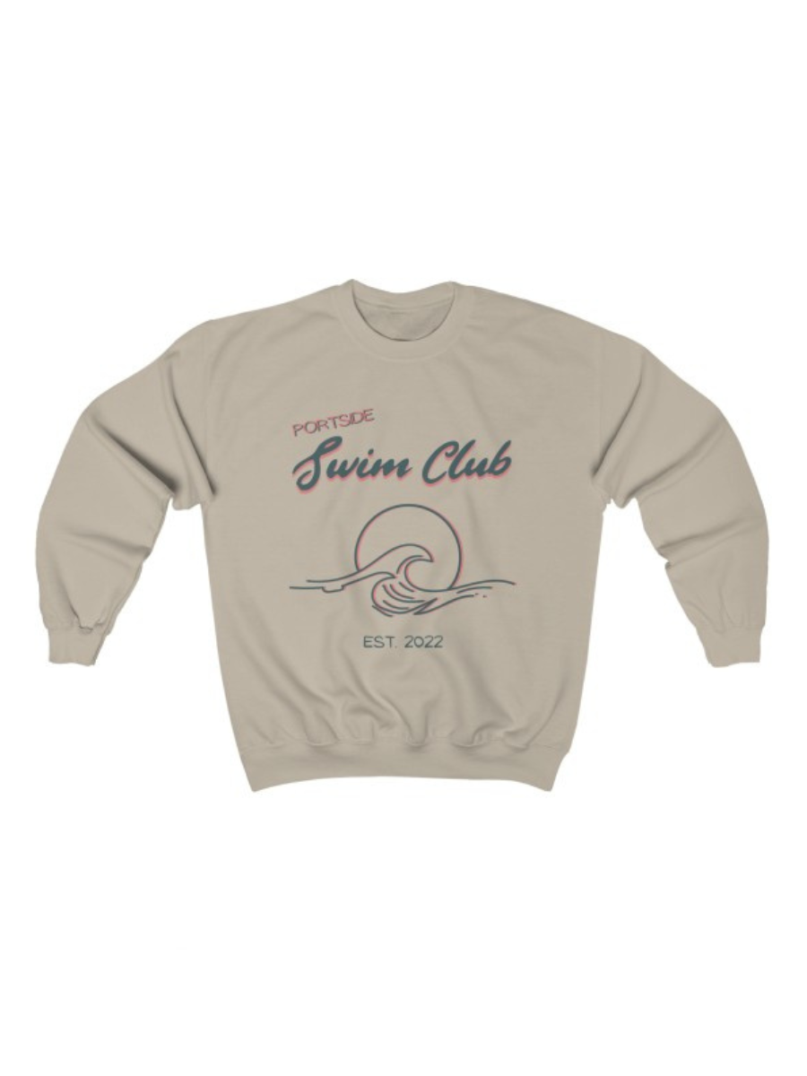 long sleeve, sand colored crewneck with a graphic of a wave in front of a circle with the words "Portside swim club" above it